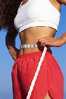 Girl measuring her waist